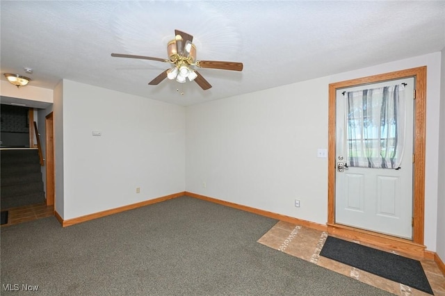 entrance foyer with carpet flooring and ceiling fan