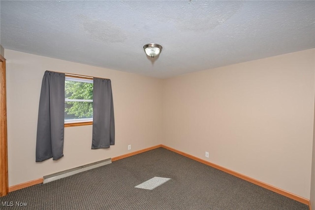 carpeted spare room featuring a textured ceiling and a baseboard heating unit