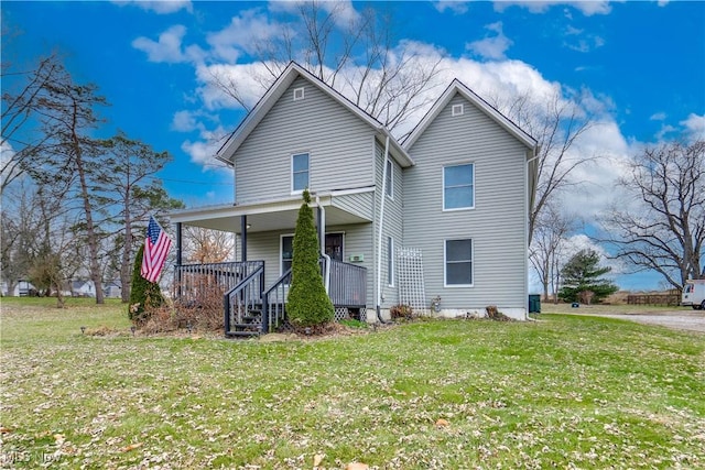 exterior space with covered porch and a front yard