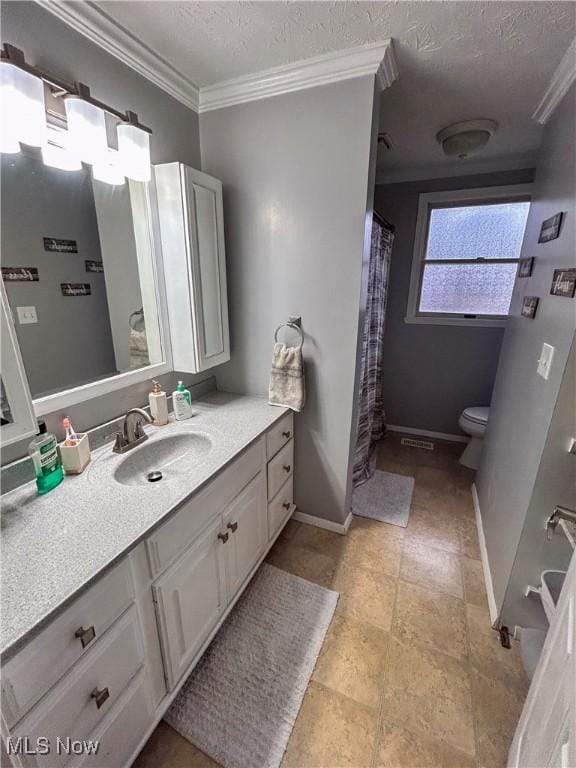 bathroom with vanity, crown molding, toilet, and a textured ceiling