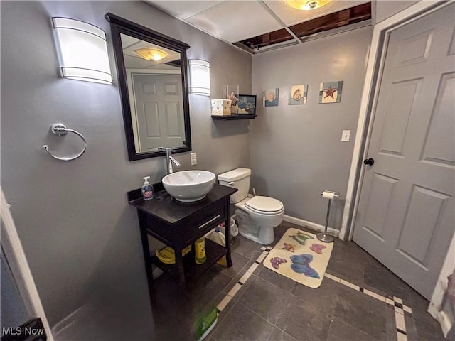 bathroom with vanity, toilet, and tile patterned flooring