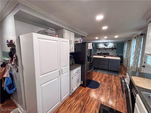 kitchen with dark wood-type flooring, black fridge, white cabinetry, ornamental molding, and gray cabinets