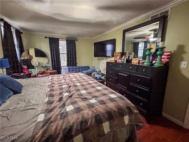 bedroom featuring ornamental molding and a textured ceiling