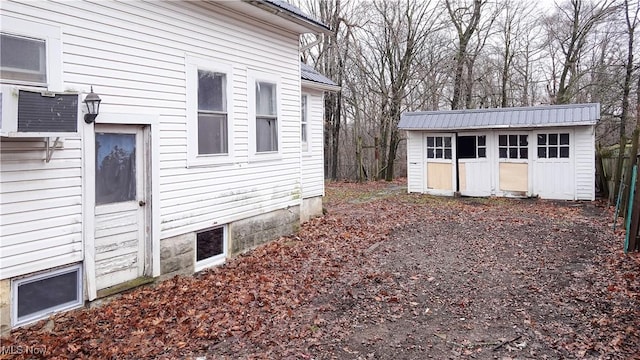 view of property exterior featuring a storage shed