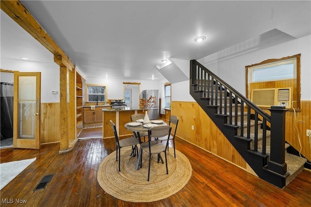 dining space featuring built in shelves and dark wood-type flooring