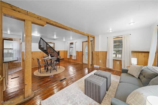 living room with wooden walls and hardwood / wood-style floors