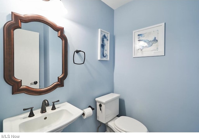 bathroom featuring toilet and sink