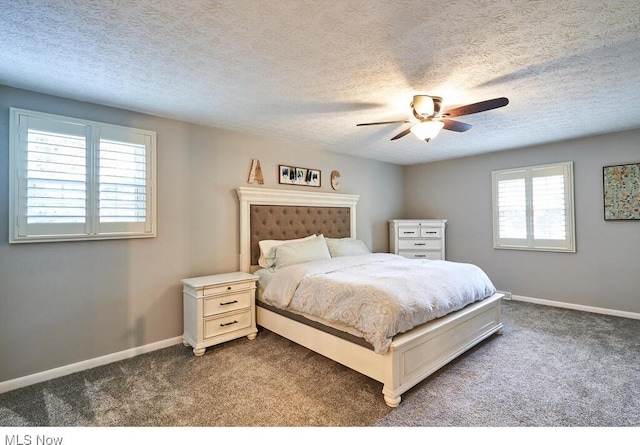 bedroom featuring ceiling fan, carpet floors, a textured ceiling, and multiple windows