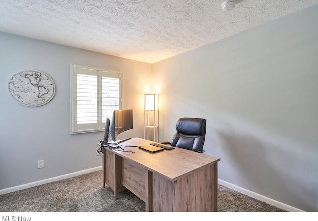 carpeted office with a textured ceiling