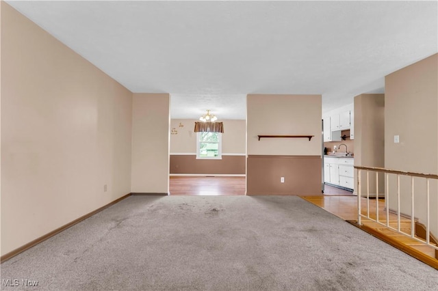 unfurnished room featuring carpet flooring and sink