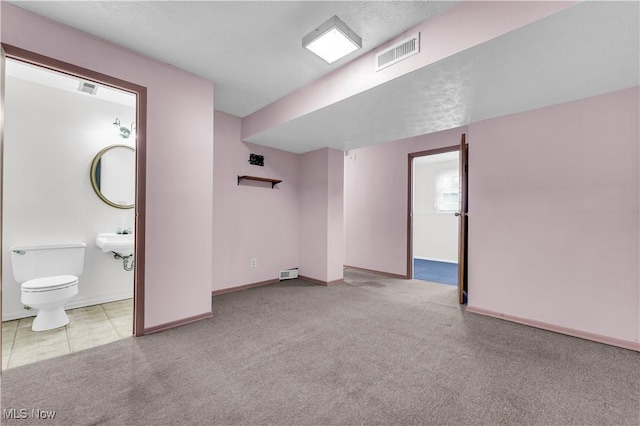 interior space featuring light colored carpet and sink