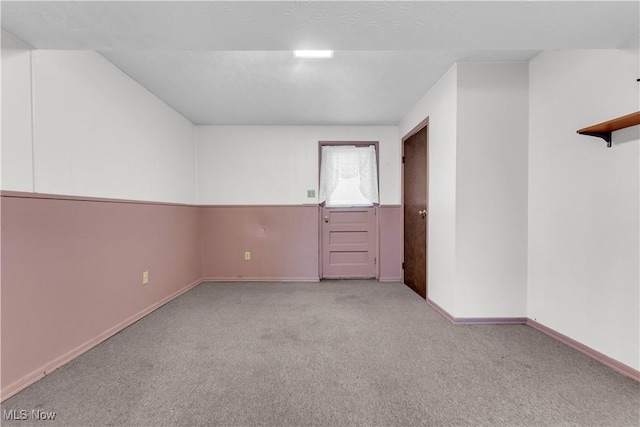 unfurnished room with light colored carpet