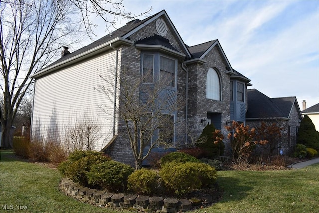 view of side of property with a lawn