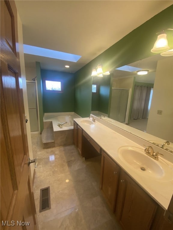 bathroom with vanity, plus walk in shower, and a skylight