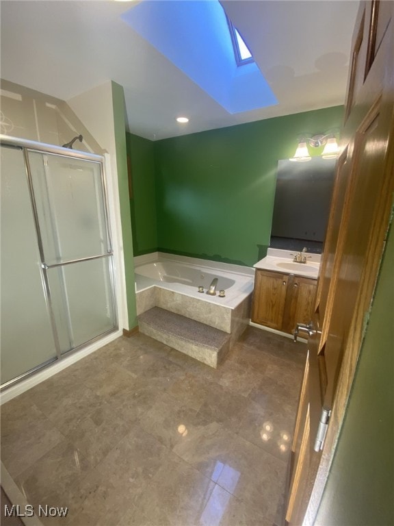 bathroom with vanity, a skylight, and independent shower and bath