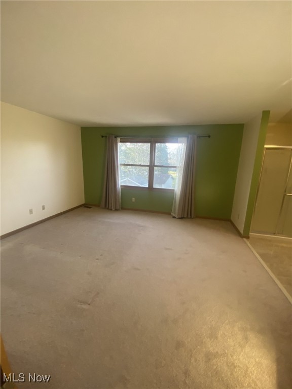 unfurnished room with carpet floors