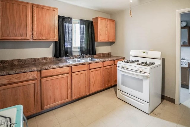 kitchen with range, white gas range, and sink