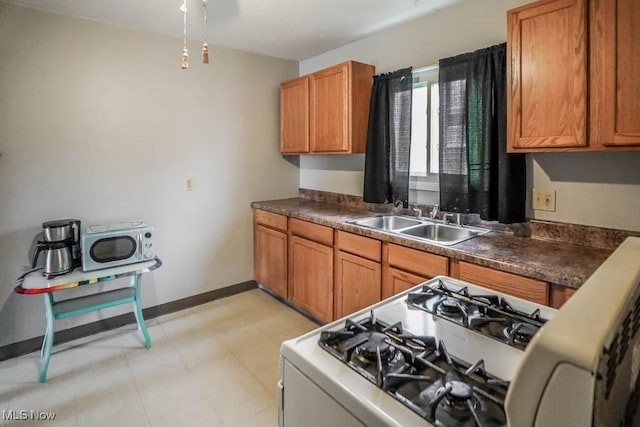 kitchen featuring gas stove and sink