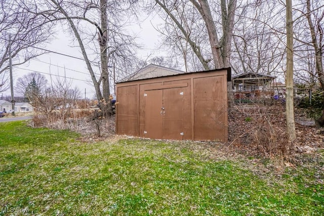 view of outbuilding with a lawn