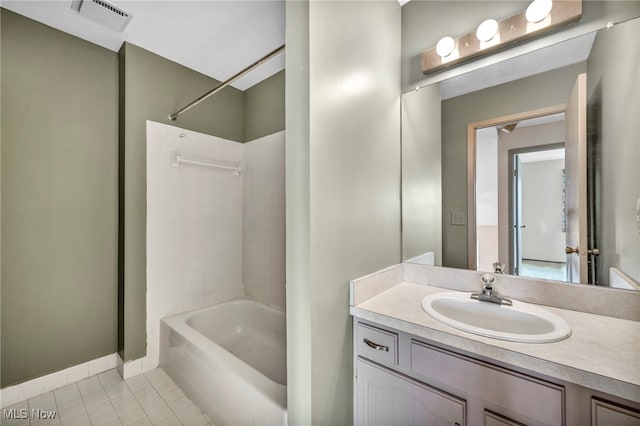 bathroom with tile patterned flooring, vanity, and bathing tub / shower combination