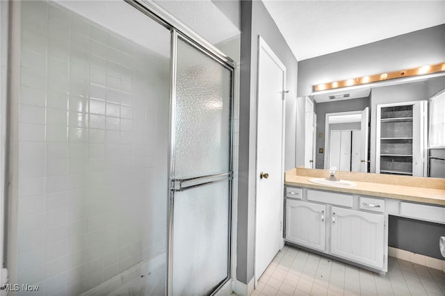 bathroom featuring vanity and a shower with shower door