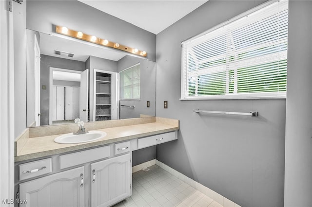 bathroom with tile patterned flooring and vanity