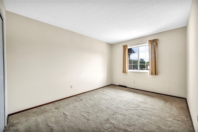 unfurnished room with carpet floors