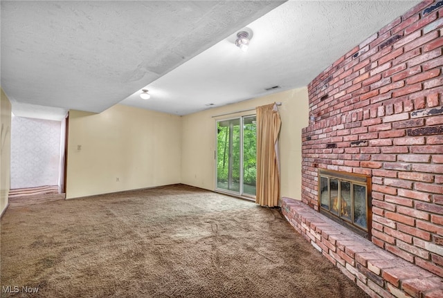 unfurnished living room featuring carpet, a textured ceiling, and a fireplace