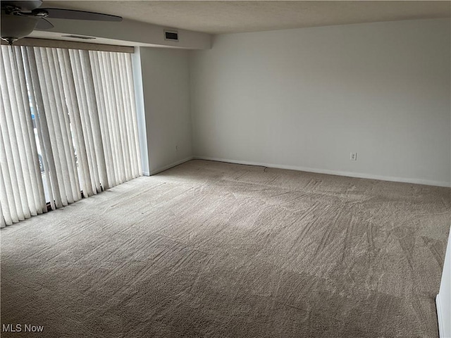 unfurnished room with light colored carpet and ceiling fan