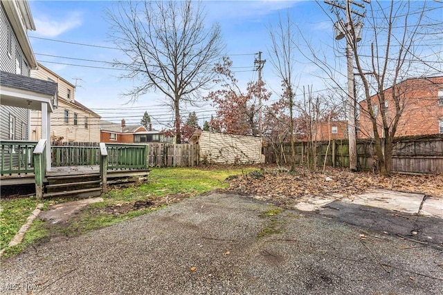 view of yard with a patio and a wooden deck