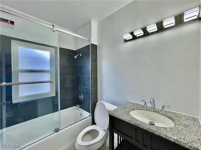 full bathroom with vanity, toilet, and enclosed tub / shower combo