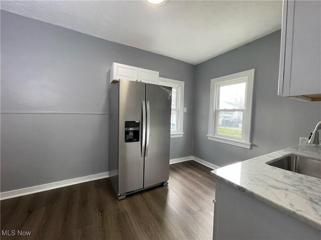 kitchen featuring white cabinets, stainless steel fridge, sink, and dark wood-type flooring