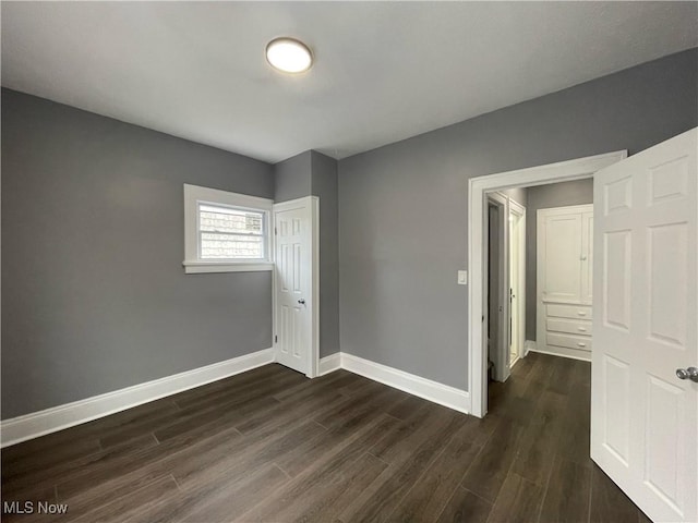 spare room with dark hardwood / wood-style flooring