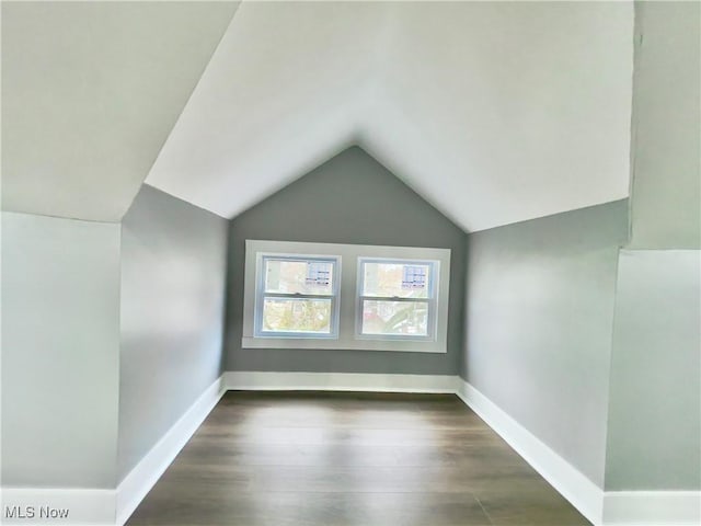 bonus room featuring dark hardwood / wood-style flooring and lofted ceiling