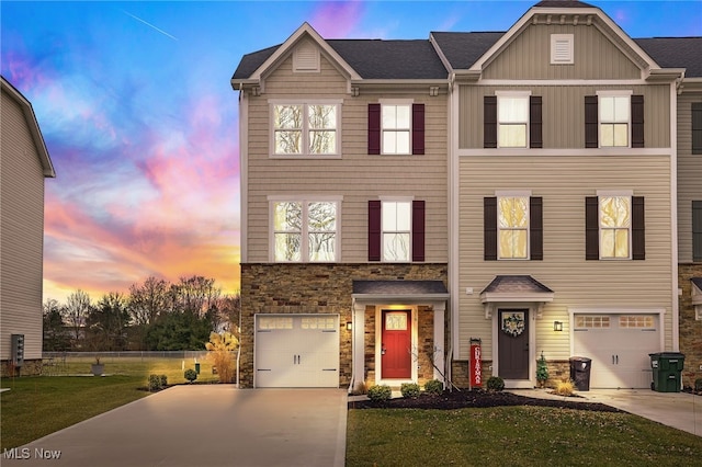 view of front of house featuring a garage and a lawn