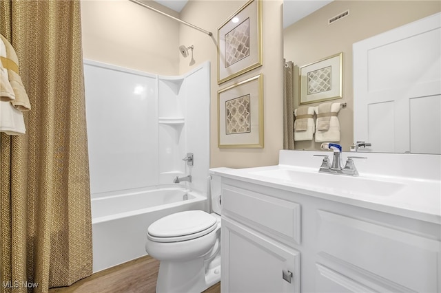 full bathroom featuring vanity, hardwood / wood-style flooring, toilet, and shower / bath combo with shower curtain