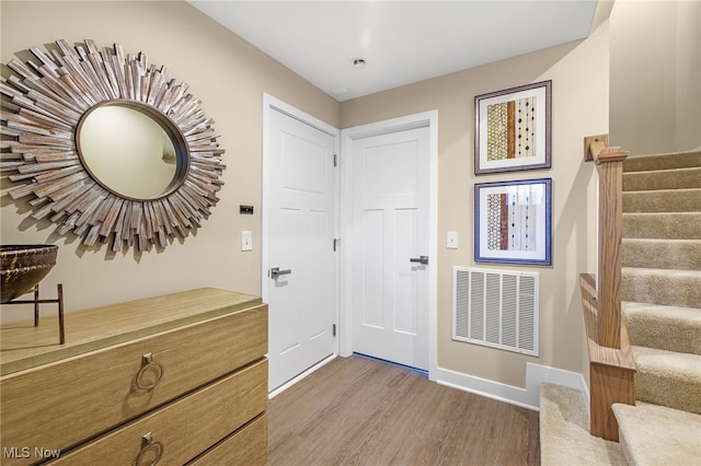 foyer entrance with hardwood / wood-style flooring