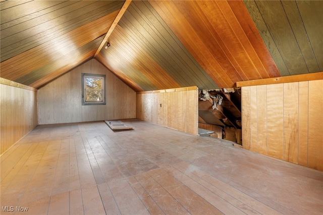 additional living space featuring lofted ceiling, wooden walls, light hardwood / wood-style flooring, and wood ceiling