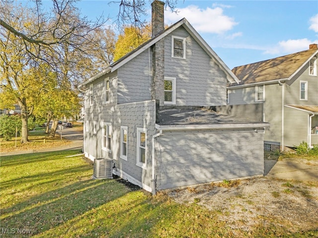 view of home's exterior featuring a yard and central AC unit