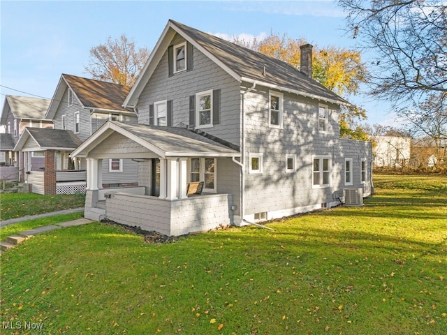 view of side of home with cooling unit and a lawn