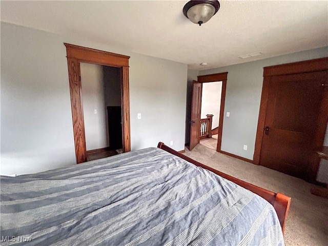 bedroom featuring light colored carpet