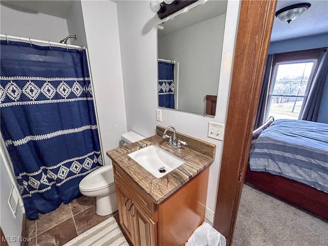 bathroom with tile patterned floors, a shower with curtain, vanity, and toilet