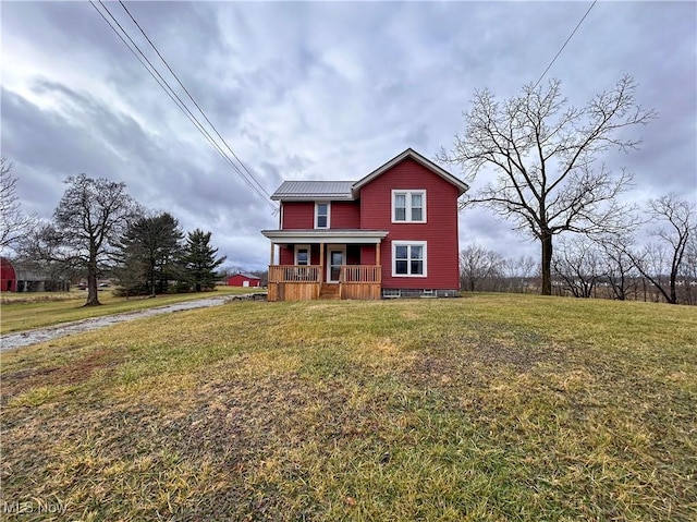 view of front of house with covered porch and a front lawn