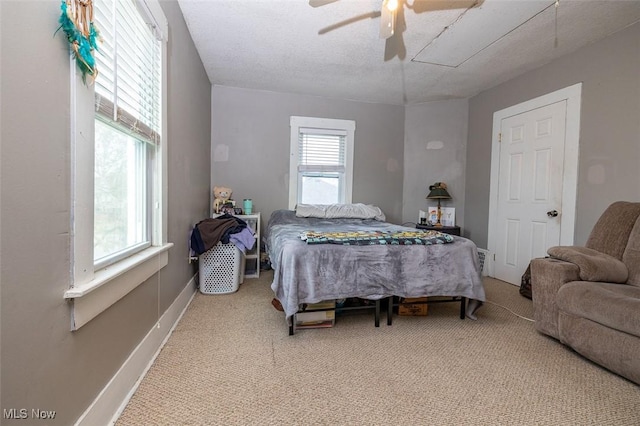 bedroom with carpet flooring, ceiling fan, and a textured ceiling