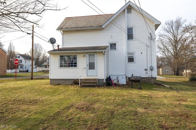 back of house with a yard