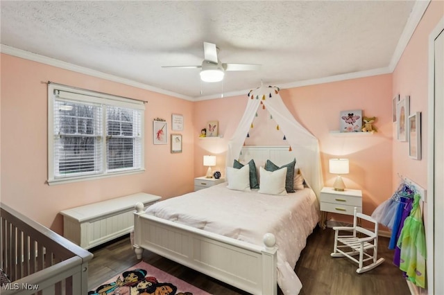 bedroom with ceiling fan, crown molding, dark wood-type flooring, and a textured ceiling