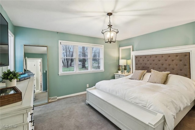 carpeted bedroom featuring a notable chandelier