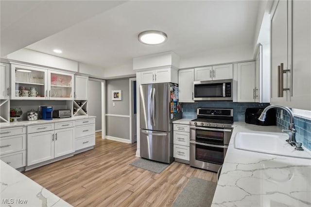 kitchen with white cabinetry, sink, and appliances with stainless steel finishes