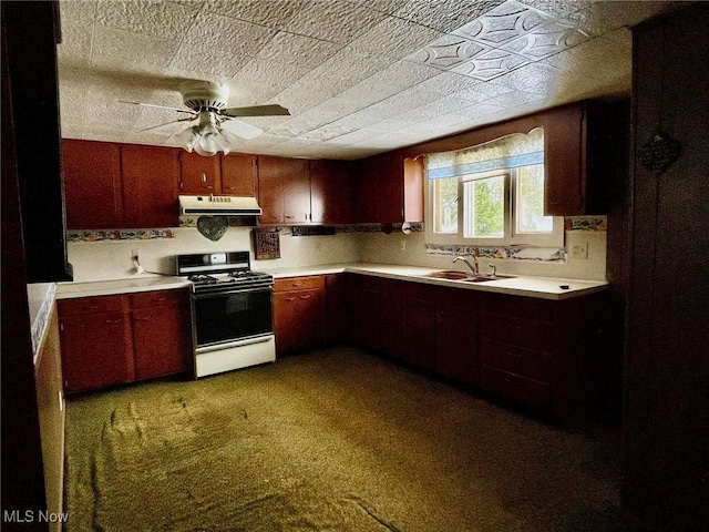 kitchen with carpet, white gas stove, ceiling fan, and sink