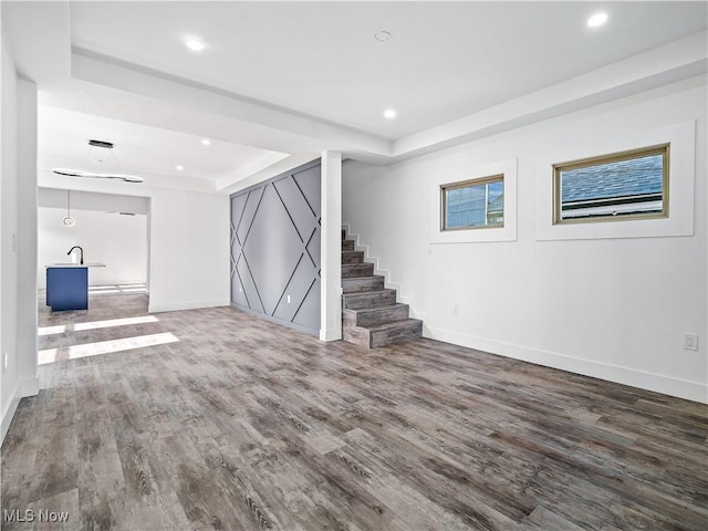 basement with hardwood / wood-style flooring